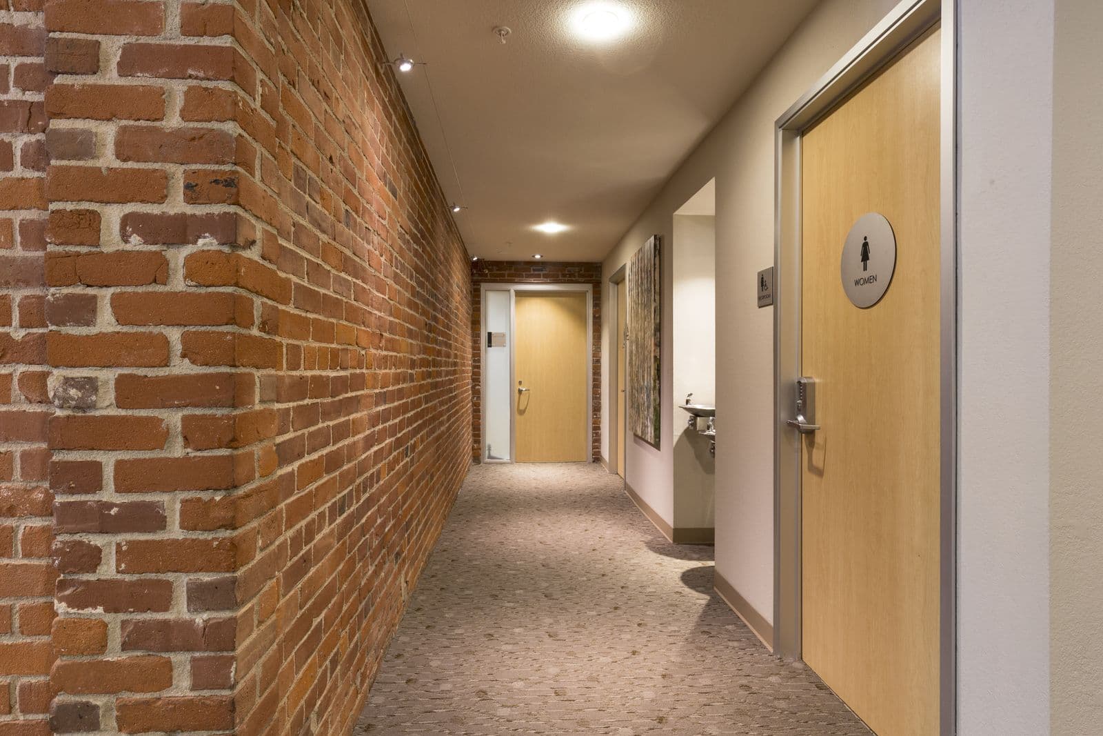 Corridor with exposed brick wall