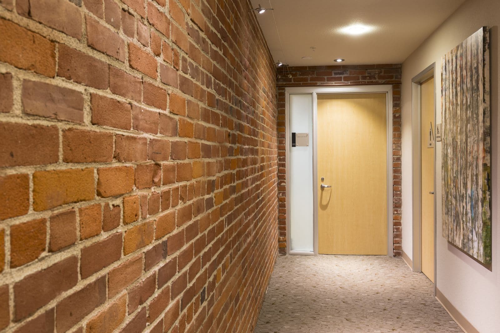 Exposed-brick corridor leading to office suites