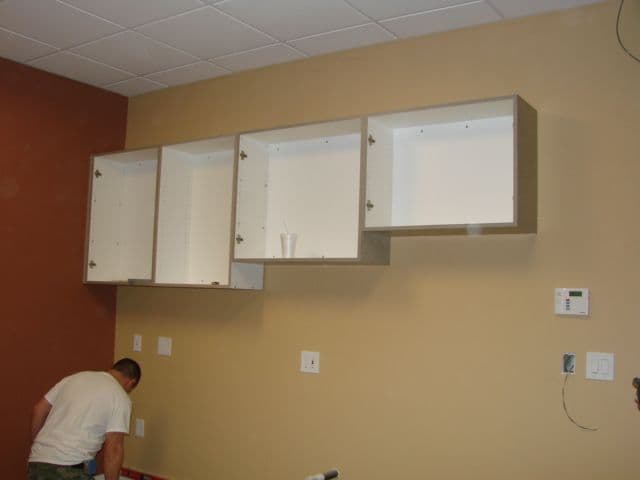 During construction: upper cabinets being installed