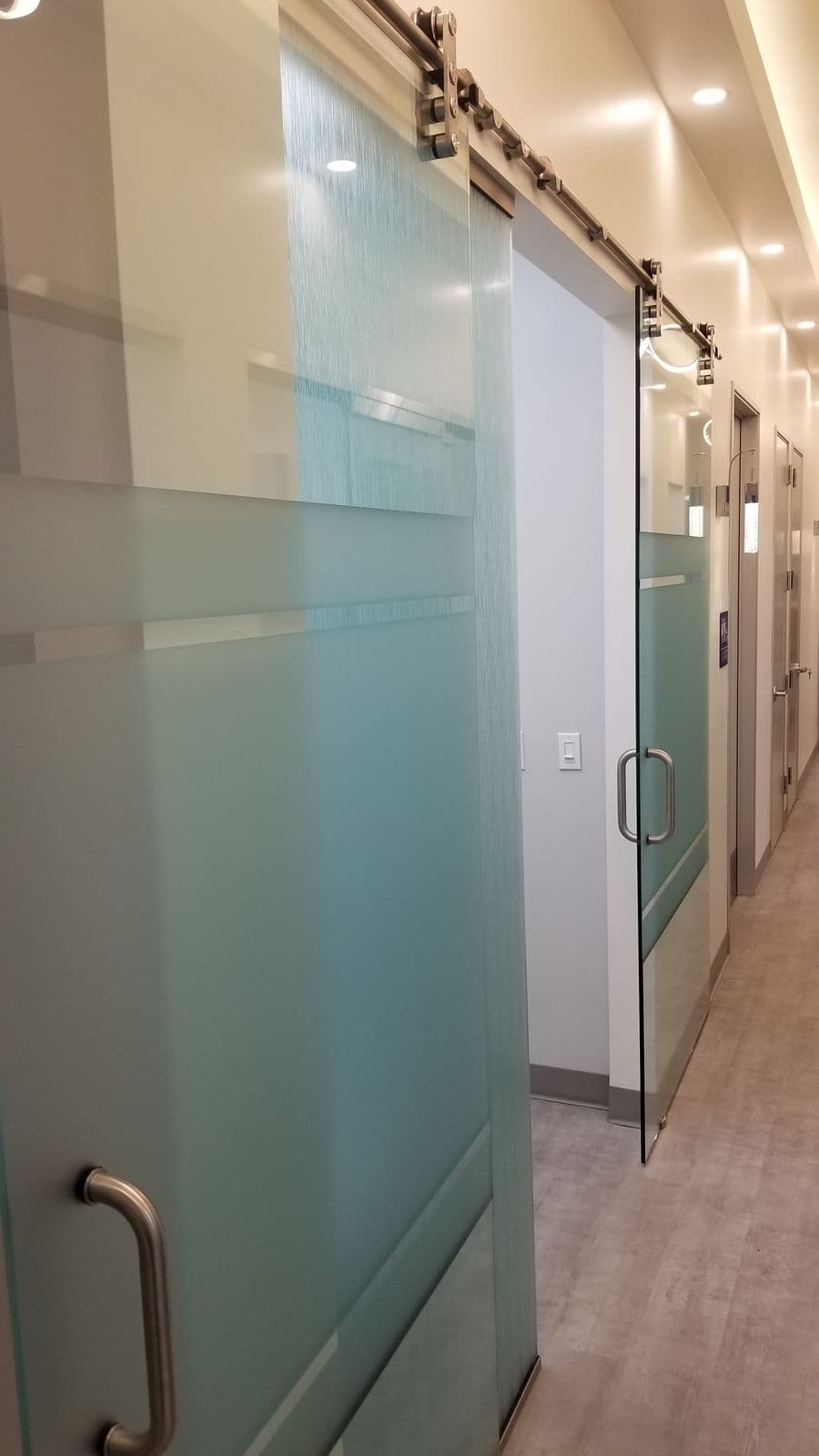 Frosted-glass sliding barn doors on private offices
