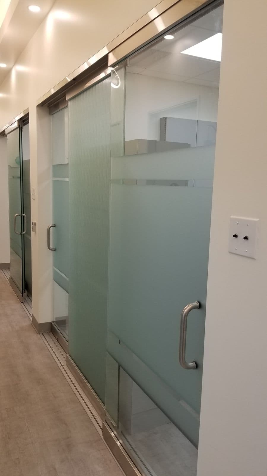 Corridor of sliding glass office fronts