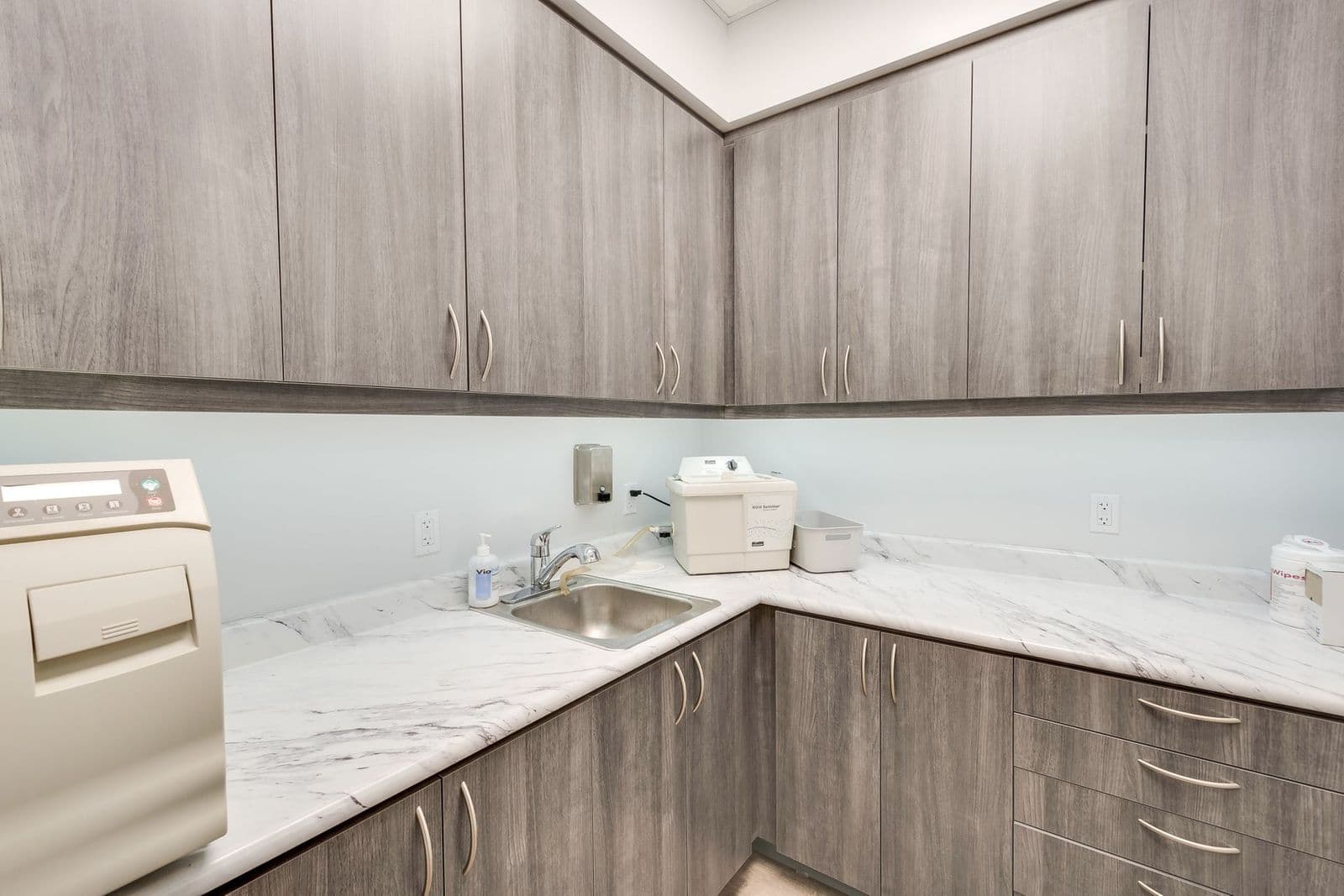 Sterilization area with gray casework and quartz-look counters